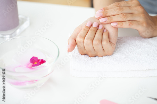 Woman hands receiving a manicure in beauty salon.