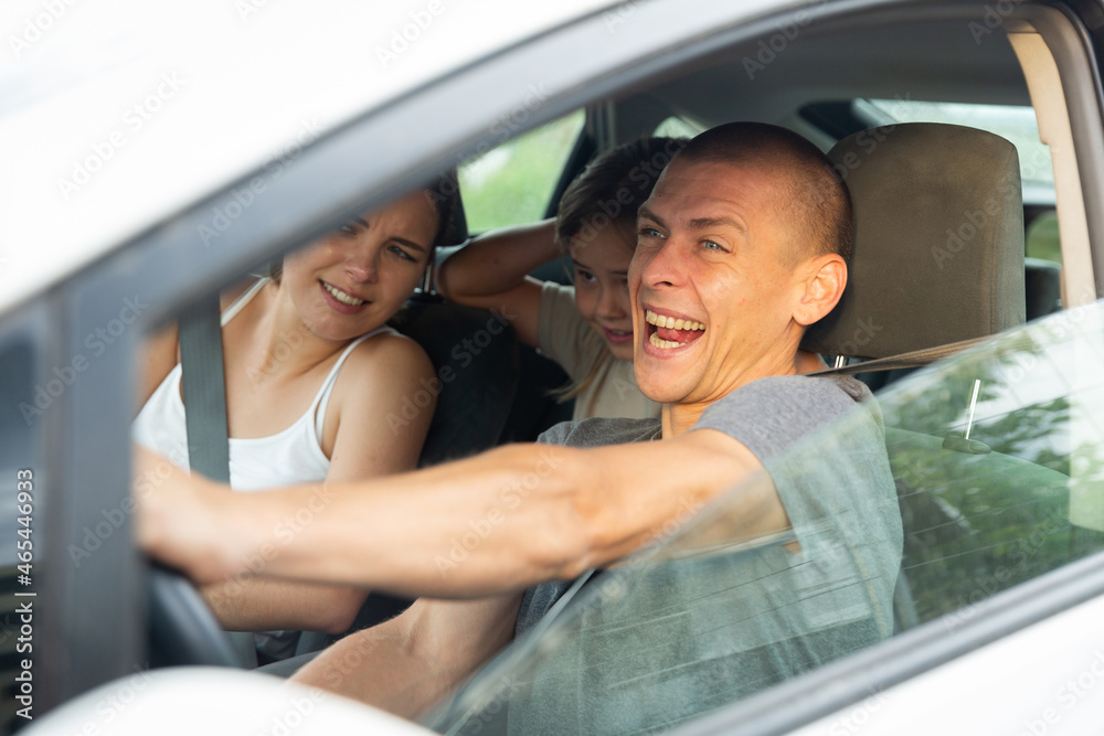 Naklejka premium Shocked family frightened of accident or collision. Man driving car during trip with his family, woman and little girl
