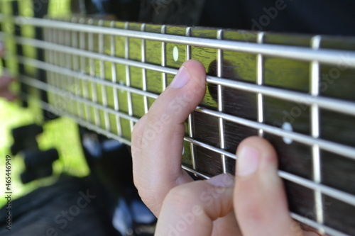 Boy playing chords on the bass guitar