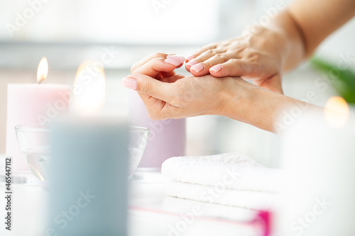 Woman hands receiving a manicure in beauty salon.