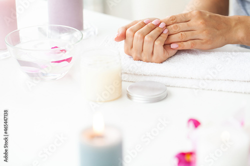 Woman hands receiving a manicure in beauty salon.