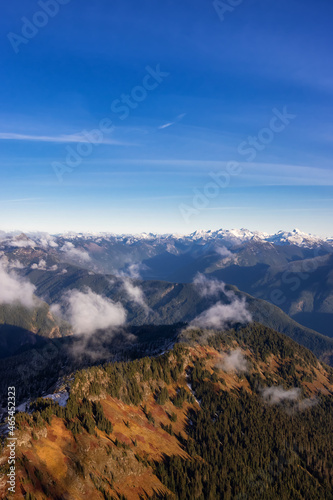 Aerial View of Canadian Rocky Mountains with snow on top during Fall Season. Nature Landscape located near Chilliwack, East of Vancouver, BC, Canada.