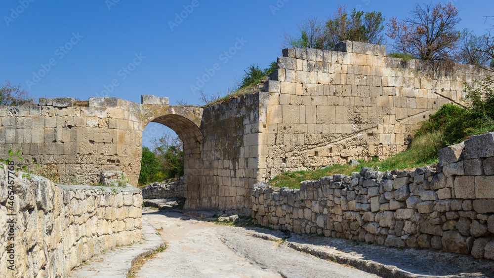 arch of stone, a partially destroyed wall in a cave city