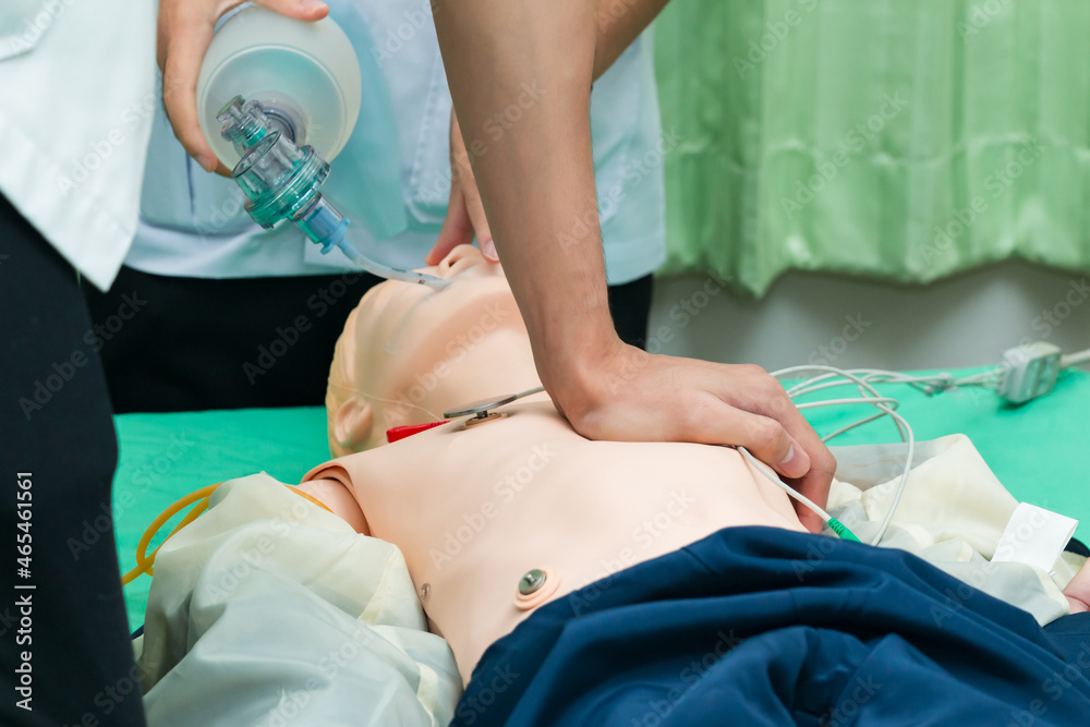 custom made wallpaper toronto digitalDemonstrating CPR (Cardiopulmonary resuscitation) training medical procedure on CPR doll in the class.Paramedic demonstrate first aid practice for save life.Doctor holding breathing bag(Ambu bag).