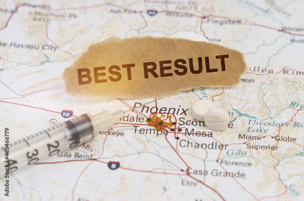 On the map of Arizona lies a syringe, pills and paper with the inscription - BEST RESULT