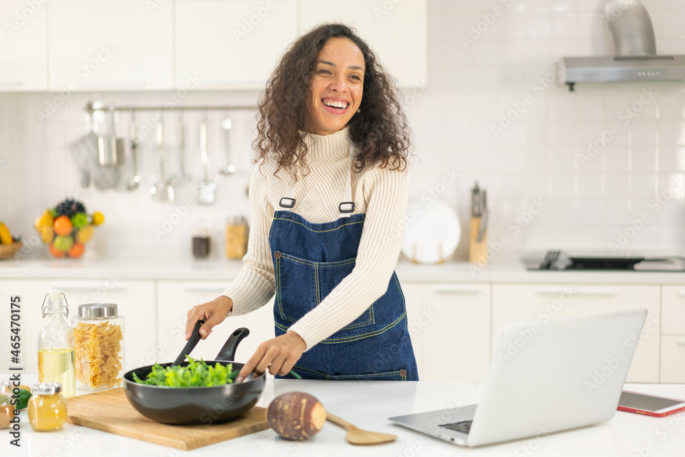 Latin woman shooting video and cooking at the kitchen Latin woman shooting video and cooking at the kitchen