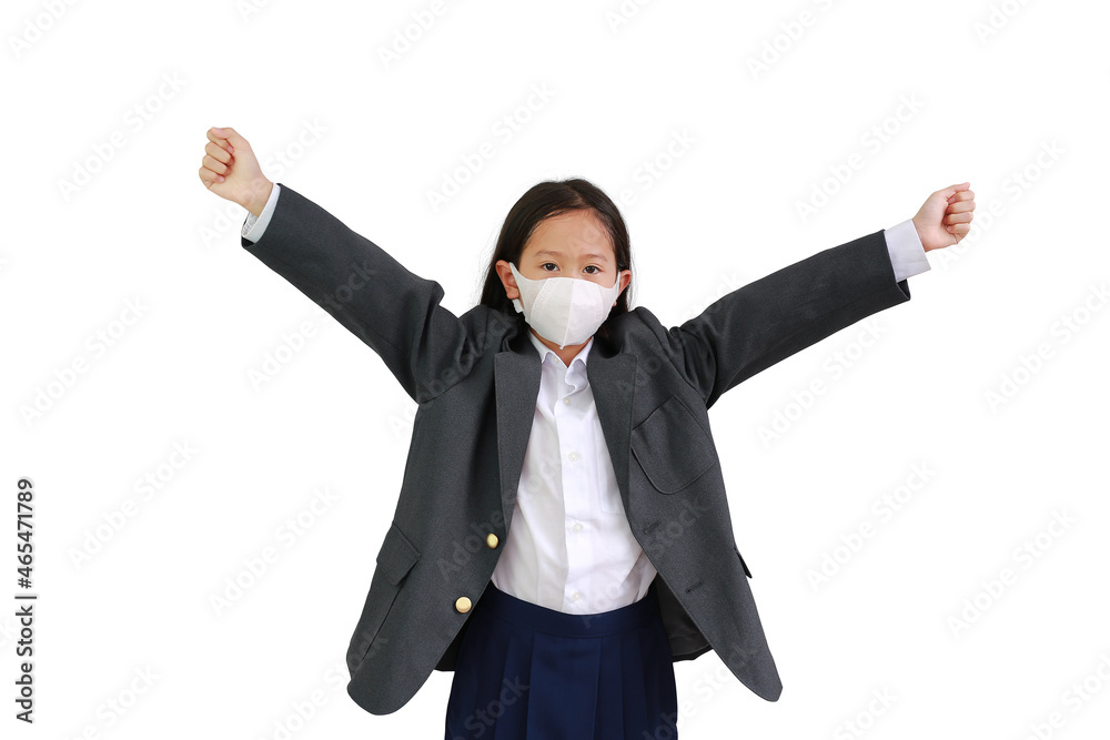 Asian little girl child in formalwear shirt, student suit and protective face mask raise hands up over white background. Asian little girl child in formalwear shirt, student suit and protective face mask raise hands up over white background.