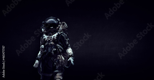 Astronaut in suit against black background. Space technology concept . Mixed media