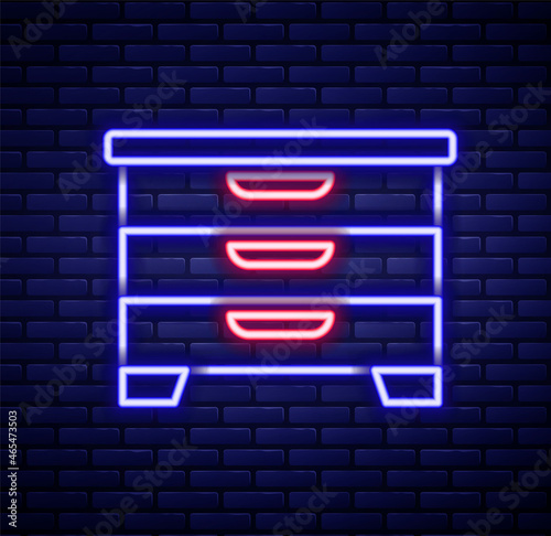 Glowing neon line Chest of drawers icon isolated on brick wall background. Colorful outline concept. Vector