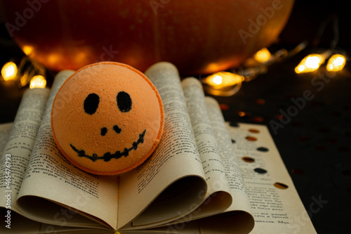 Haluin bath bomb lying on a book in the dark photo