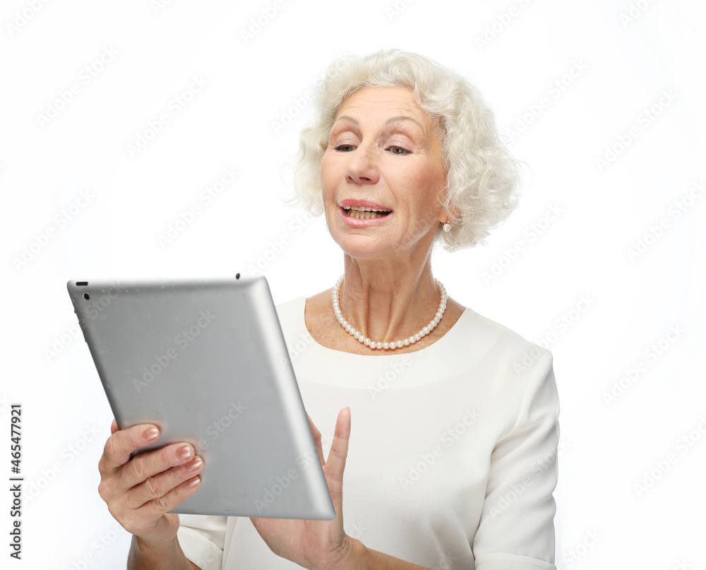lifestyle, technology and old people concept: Happy mature woman using a tablet over white background lifestyle, technology and old people concept: Happy mature woman using a tablet over white background