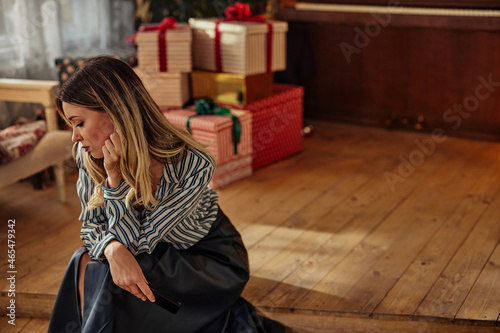 Pensive and lonely woman during christmas celebration days photo