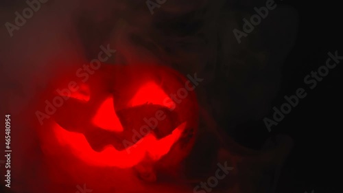 Smoke coming out of the pumpkin face inside the dark during the halloween in Estonia