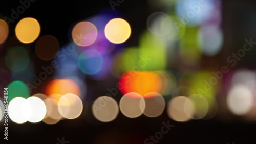 Soft focus lights moving in a night time city setting