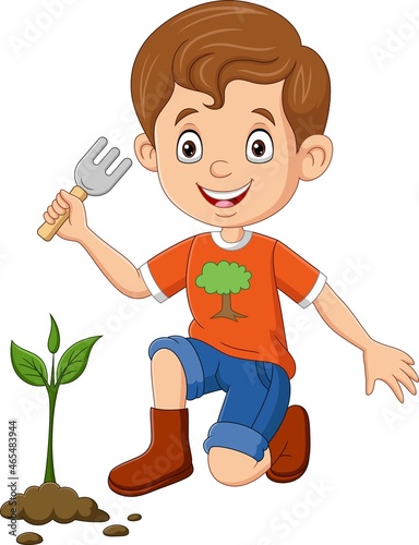 Cute little boy planting a plant