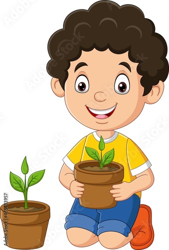 Cute little boy holding plants in pot