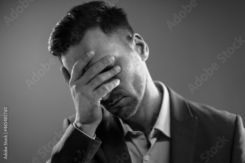 Tired Businessman After a Hard Day. Office Manager Touching His Face. Boss is Disappointed. Black and White Portrait. High quality photo © Svetlana
