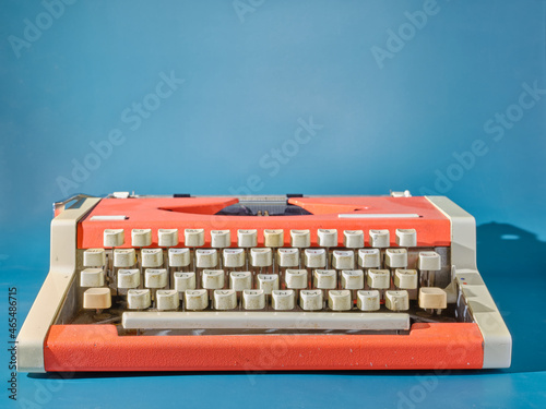 Red typewriter on blue background