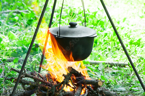 cast iron cauldron on fire. cooking on a hike. outdoor recreation concept