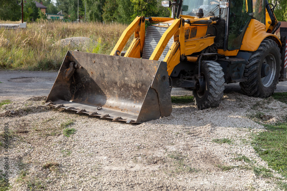 The tractor is working with rubble on the road. The tractor is working with rubble on the road.