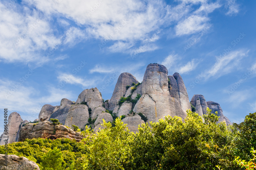 Views of the Montserrat massif or mountain province of Barcelona, Catalonia, on a day with white clouds and blue sky.