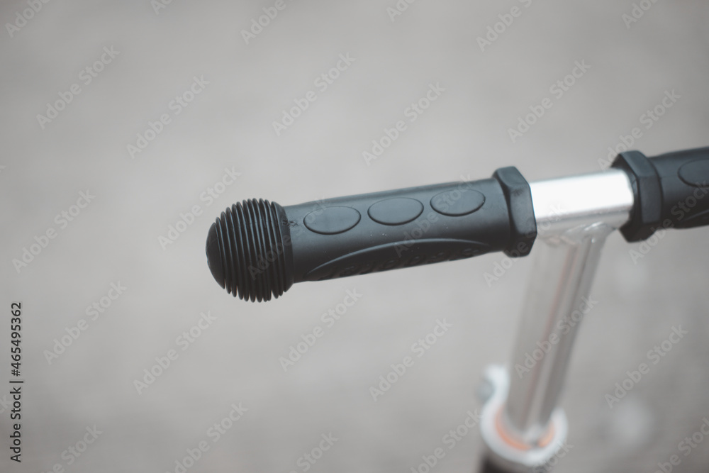 Handlebar on a kid scooter. Selective focus. Handlebar on a kid scooter. Selective focus.