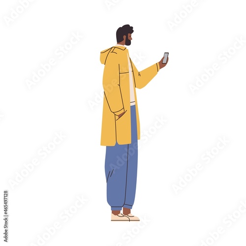 Man standing with mobile phone in hand, surfing internet and social media onl...