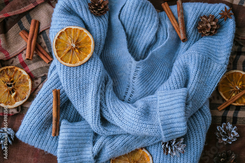 Blue sweater and cinnamon sticks and anise star. Dry slices of citrus orange and cones. Hot winter cocktail. Christmas, Thanksgiving drinks. Autumn, grog, hot sangria, mulled wine photo