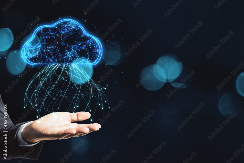 Close up of businessman hand holding glowing blue digital cloud with binary code on dark blurry bokeh background with mock up place. Computing and coding concept. Close up of businessman hand holding glowing blue digital cloud with binary code on dark blurry bokeh background with mock up place. Computing and coding concept.