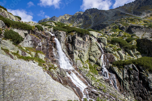 View of the mountain waterfall Skok (vodopad Skok, Vysoke Tatry) with no people, located at High Tatras in Slovakia. Green background HD. Wallpaper 4k. photo