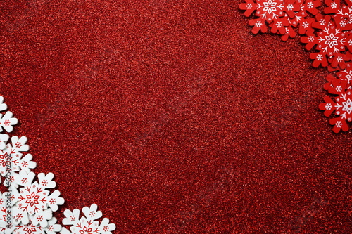 wooden snowflake border frame on red glitter background photo