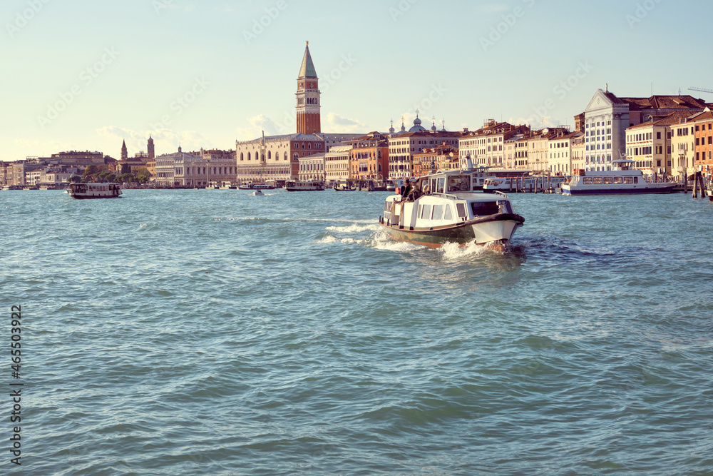 Italy, Venice, panoramic image of Riva degli Schiavoni, the Venice Promenade, with passenger boats. City skyline banner. Church Santa Maria della Salute, Doge's palace and St Mark's Campanile.