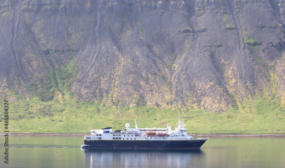 Dynjandi, Iceland on august 6, 2021: National Geographic explorer floating in the fjord near Dynjandi