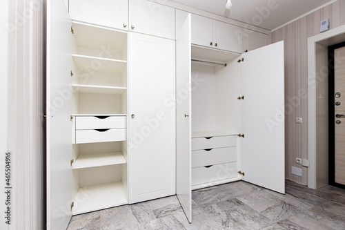 wardrobes with hinged doors on white door hinges, in the apartment