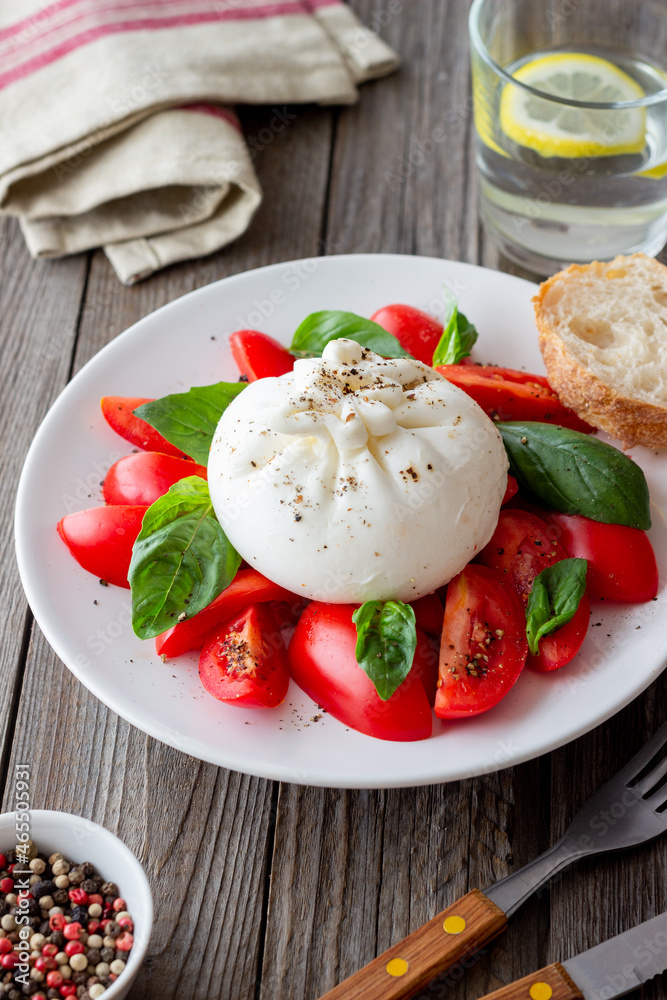 Italian burrata cheese with tomatoes and basil. Salad. Healthy eating. Vegetarian food. Italian burrata cheese with tomatoes and basil. Salad. Healthy eating. Vegetarian food.