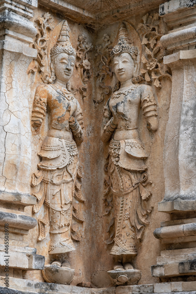 Beautiful ancient stucco carving life size deities on wall of  historic Wat Chet Yot or Wat Jed Yod buddhist temple, famous landmark of Chiang Mai, Thailand