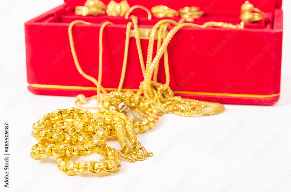 Group of gold necklace and gold ring of accessories in red box.