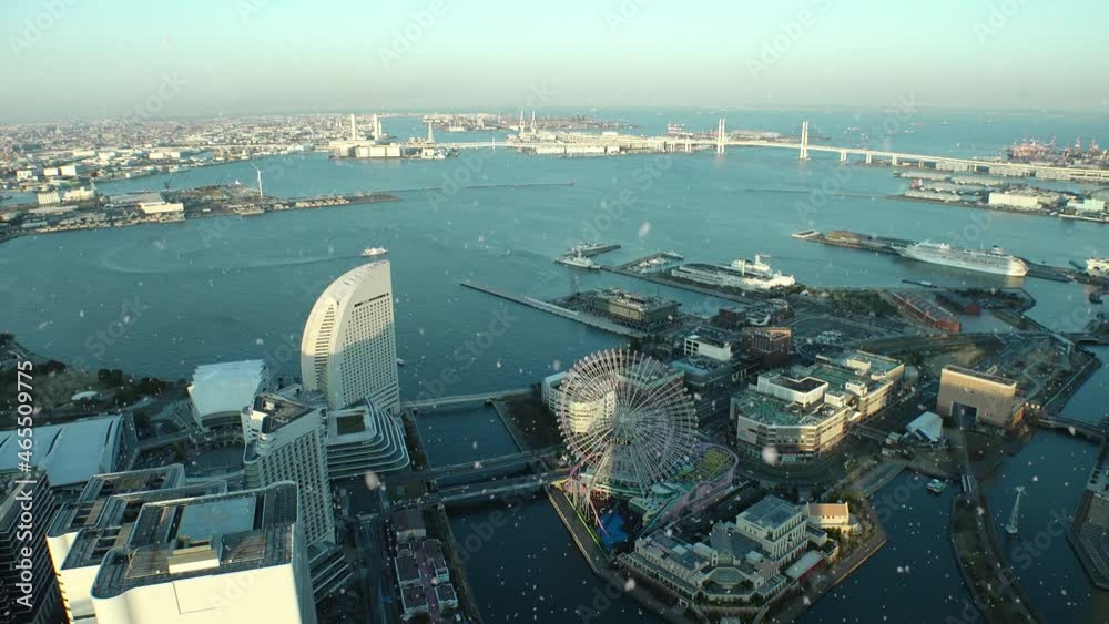 SAKURAGICHO, YOKOHAMA, JAPAN : Aerial view of cityscape of Yokohama and snow. View around Minato mirai (harbor, port, sea) area. Japanese winter and romantic Christmas concept. Sunset or sunrise shot.