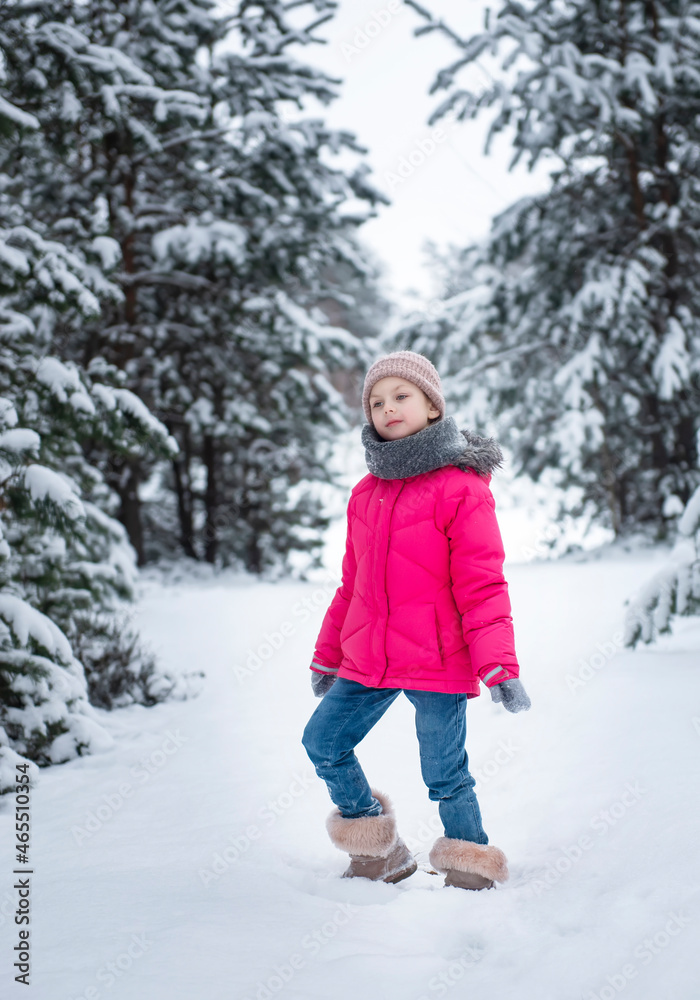 Child in winter. A little girl,  playing in the winter outside.