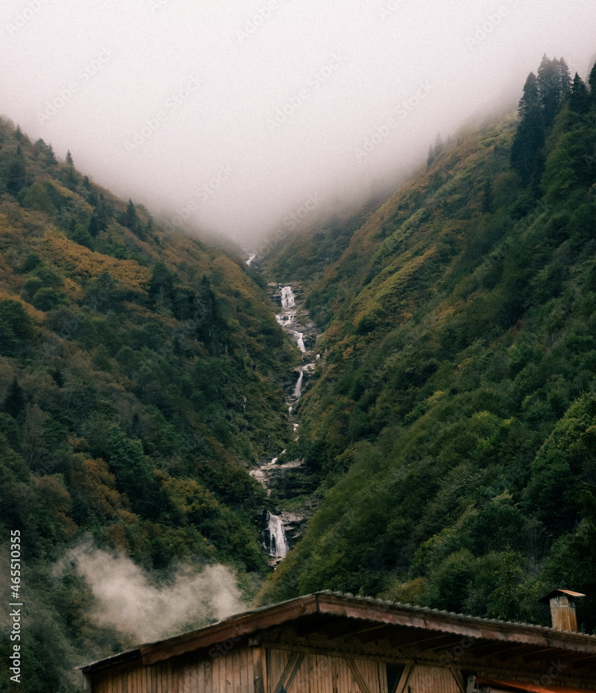 waterfall in the mountains. foggy landscape