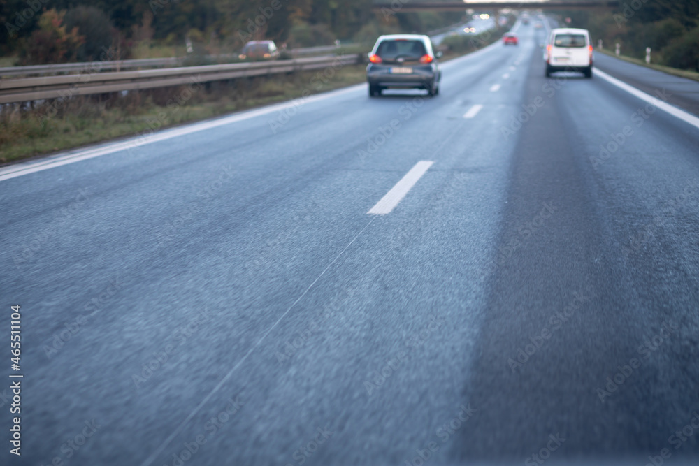 low trafflic on german highway, red backlights, cars, motion blur, focus on asphalt in the front low trafflic on german highway, red backlights, cars, motion blur, focus on asphalt in the front