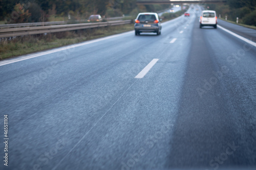 low trafflic on german highway, red backlights, cars, motion blur, focus on asphalt in the front © Stockhausen