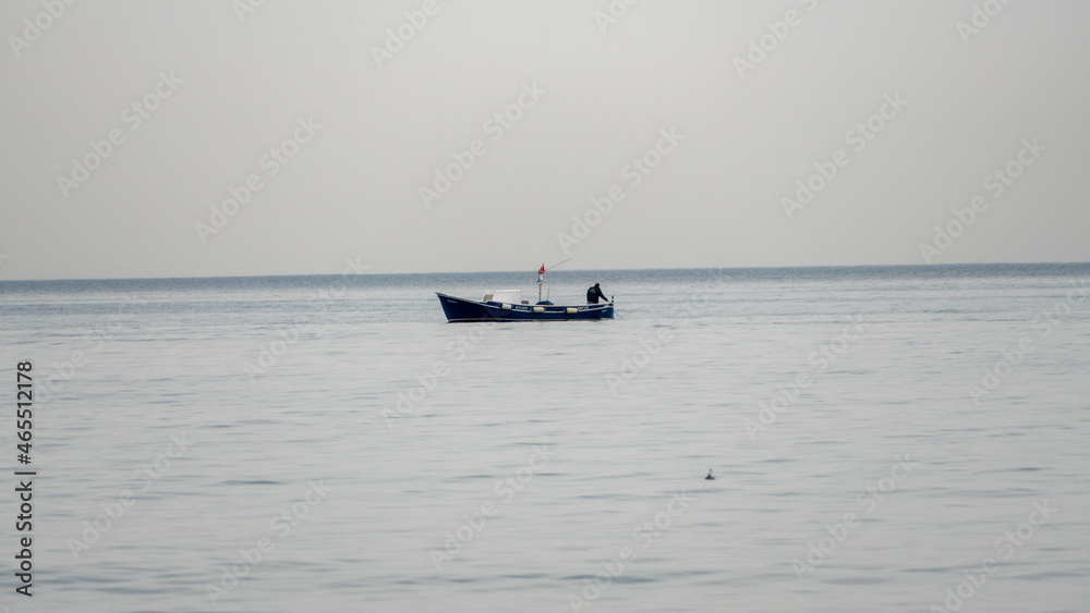 Naklejka premium Peaceful Fishing Moment on the Water, fishing boat in the sea, fishing boat and sea background, fishing boat and sea wallpaper, a fishing boat wallpaper, fishing in the sea