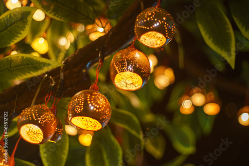 bokeh of Beautiful handmade lantern lamp made from (Strychnos nux-blanda A.W. Hill), fruits. On the trees at night of a traditional Thai festival celebrates. Event for The End of Buddh photo