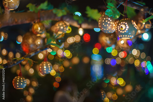 bokeh of Beautiful handmade lantern lamp made from (Strychnos nux-blanda A.W. Hill), fruits. On the trees at night of a traditional Thai festival celebrates. Event for The End of Buddh