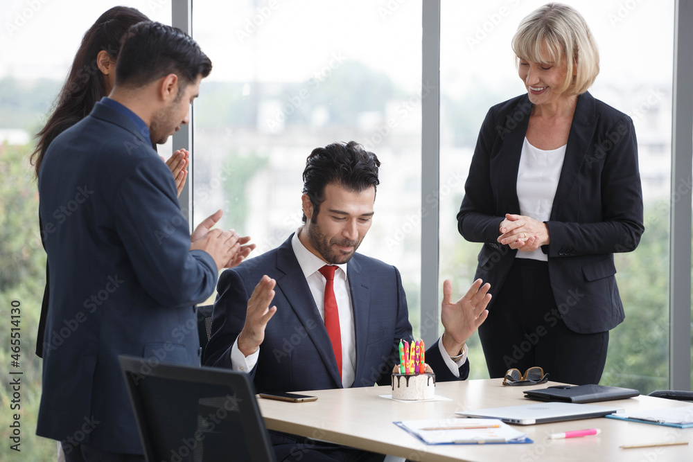 Group of business people celebrating birthday with cake to colleague in office. worker team Group of business people celebrating birthday with cake to colleague in office. worker team