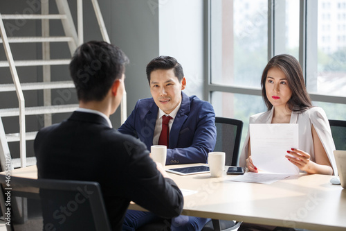 group of business people in suits and Human resources manager female interviewing new worker or employee . serious interviewer woman in job interview