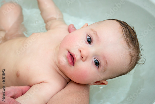 little baby girl bathing in the bathroom