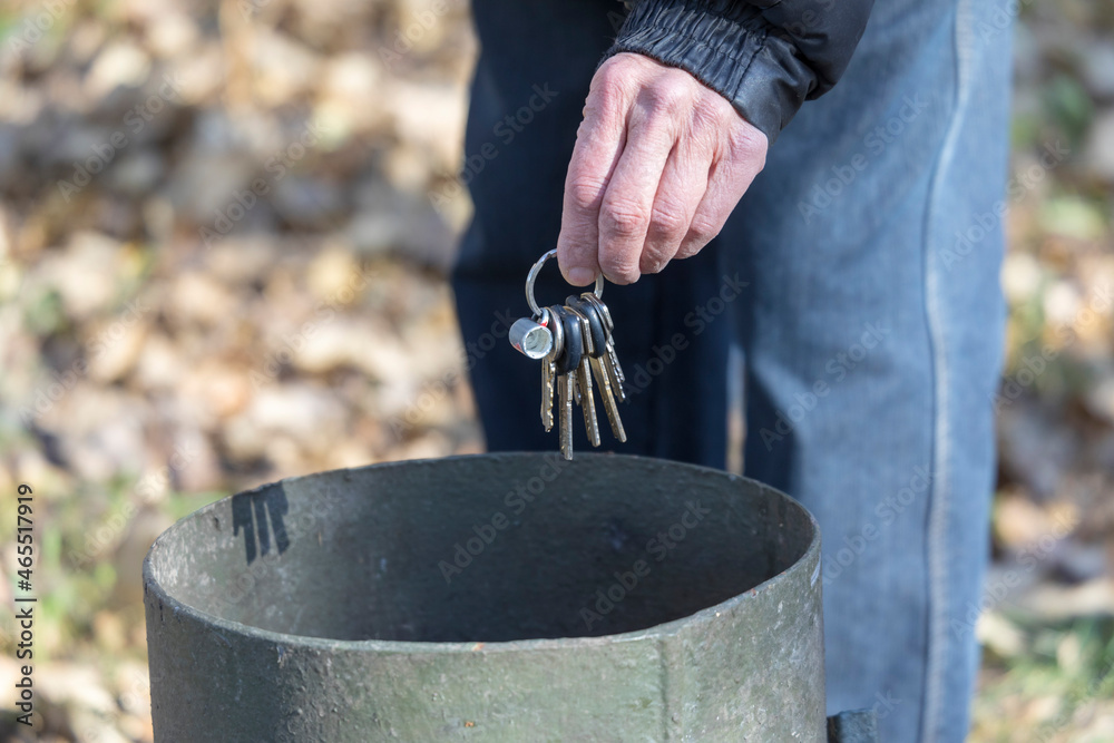An old man throws a bunch of keys in the trash Stock Photo Adobe Stock