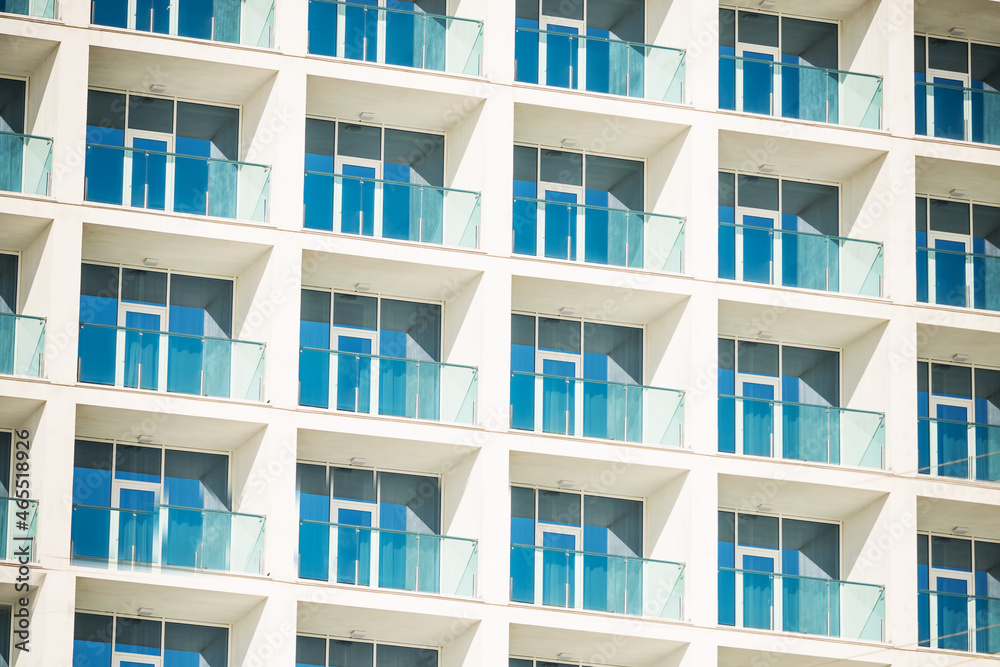 The pattern of the windows and balconies of the building. House wall with windows. The pattern of the windows and balconies of the building. House wall with windows.